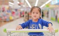 Asian little child girl sitting in the trolley during family shopping in the market Royalty Free Stock Photo