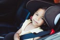 Asian little child girl smiling and sitting in the car seat Royalty Free Stock Photo
