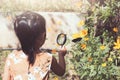 Asian little child girl using magnifying glass watching butterfly Royalty Free Stock Photo