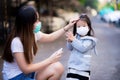 Asian little child girl was washing her hands with an alcohol spray that her mother sprayed. Royalty Free Stock Photo