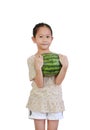 Asian little child holding fresh green watermelon on pink isolated background Royalty Free Stock Photo