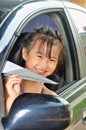 Asian little child holding paper plane in the car Royalty Free Stock Photo