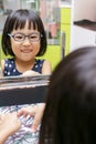 Asian Little Chinese Girl Choosing Glasses