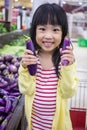 Asian Little Chinese Girl choosing vegetables