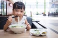 Asian little Chinese girl eating beef noodles soup Royalty Free Stock Photo