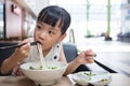 Asian little Chinese girl eating beef noodles soup