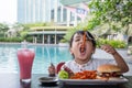 Asian Little Chinese Girl Eating Burger and French fries