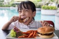 Asian Little Chinese Girl Eating Burger and Fried chicken Royalty Free Stock Photo