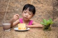 Asian little Chinese girl eating delicious cake