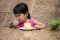 Asian little Chinese girl eating delicious cake