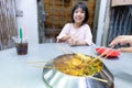 Asian Little Chinese Girl eating hot pot in a restaurant