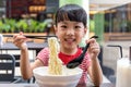 Asian little Chinese girl eating noodles soup Royalty Free Stock Photo