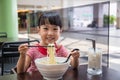 Asian little Chinese girl eating noodles soup Royalty Free Stock Photo