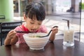 Asian little Chinese girl eating noodles soup Royalty Free Stock Photo