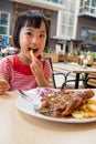 Asian Little Chinese Girl Eating Western Food Royalty Free Stock Photo