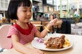 Asian Little Chinese Girl Eating Western Food Royalty Free Stock Photo