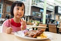 Asian Little Chinese Girl Eating Western Food Royalty Free Stock Photo