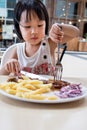 Asian Little Chinese Girl Eating Western Food Royalty Free Stock Photo