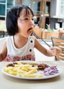 Asian Little Chinese Girl Eating Western Food Royalty Free Stock Photo