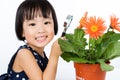 Asian Little Chinese Girl Looking at Flower through a Magnifying Royalty Free Stock Photo