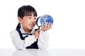 Asian Little Chinese Girl Looking At Globe Through Magnifying Glass