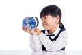 Asian Little Chinese Girl Looking At Globe Through Magnifying Glass Royalty Free Stock Photo