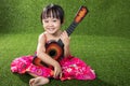 Asian Little Chinese girl playing with guitar Royalty Free Stock Photo