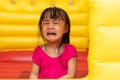 Asian Little Chinese Girl playing at inflatable castle