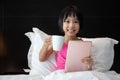 Asian Little Chinese Girl playing tablet in bed Royalty Free Stock Photo