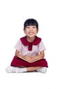 Asian Little Chinese girl sitting on floor and reading book Royalty Free Stock Photo