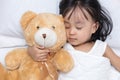 Asian little Chinese girl sleeping with teddy bear Royalty Free Stock Photo