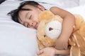 Asian little Chinese girl sleeping with teddy bear Royalty Free Stock Photo