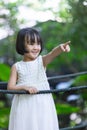 Asian Little Chinese Girl standing on a bridge