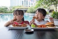 Asian Little Chinese Girls Eating Burger and Fried chicken Royalty Free Stock Photo