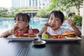 Asian Little Chinese Girls Eating Burger and Fried chicken Royalty Free Stock Photo