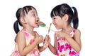 Asian Little Chinese girls eating lollipop