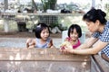 Asian Little Chinese Girls and mother playing wirh duck