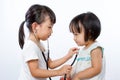 Asian Little Chinese Girls Playing as Doctor and Patient with St Royalty Free Stock Photo