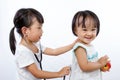 Asian Little Chinese Girls Playing as Doctor and Patient with St Royalty Free Stock Photo