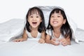 Asian little Chinese girls playing on the bed