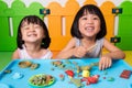 Asian Little Chinese Girls Playing with Colorful Clay