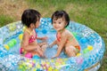 Asian Little Chinese Girls Playing in an Inflatable Rubber Swimming Pool Royalty Free Stock Photo