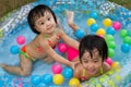 Asian Little Chinese Girls Playing in an Inflatable Rubber Swimming Pool Royalty Free Stock Photo