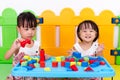 Asian Little Chinese Girls Playing Wooden Blocks