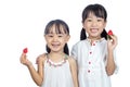 Asian Little Chinese sisters holding Strawberry