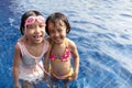 Asian Little Chinese Sisters Playing in Swimming Pool Royalty Free Stock Photo