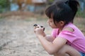 Asian little gilr holding a chick in her hand with love and happy