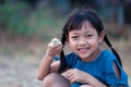 Asian little gilr holding a chick in her hand with love and happy