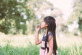 Asian little girl is blowing a soap bubbles in the park Royalty Free Stock Photo
