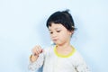 Asian little girl brushing teeth with toothbrush in hand dental hygiene - child don`t brush teeth Royalty Free Stock Photo